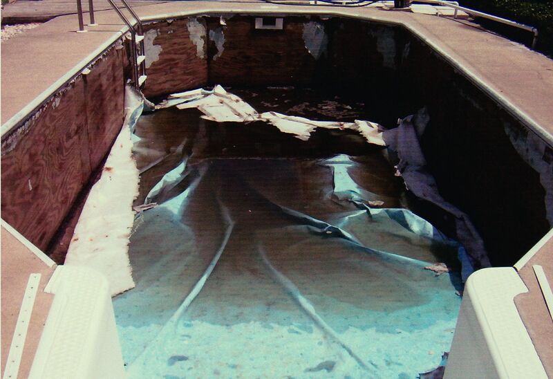 An Oval Shaped Pool With Rust Traces on the Wall
