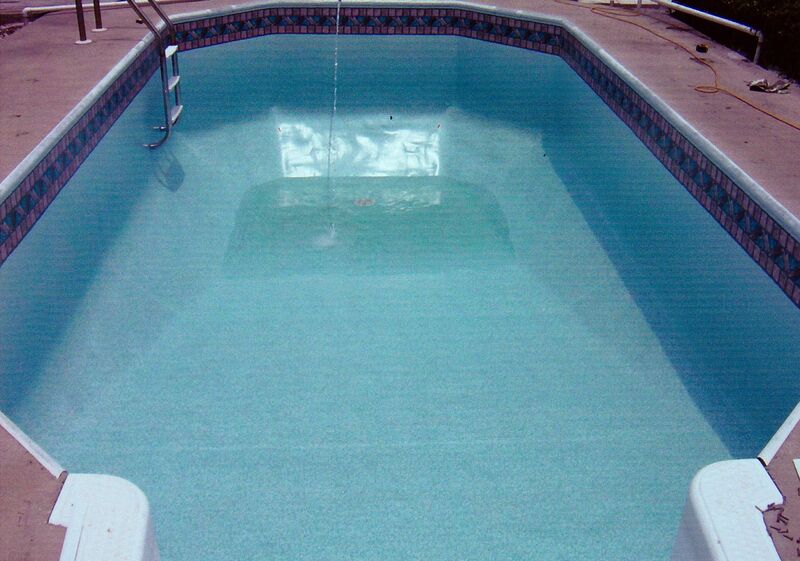 A Pool With Dark Blue Design Rim Filled With Water