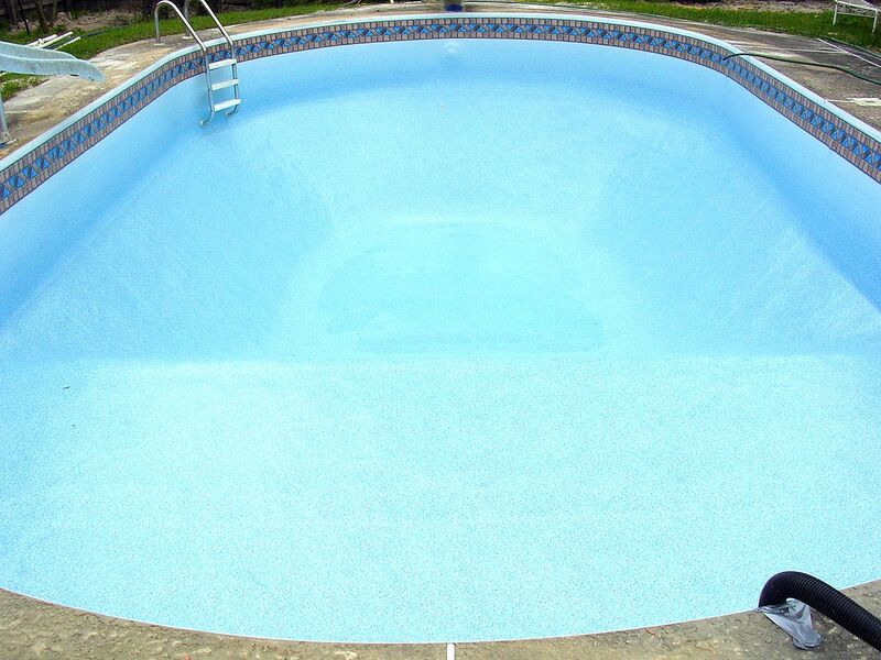 A Long Oval Pool With Water After Cleaning