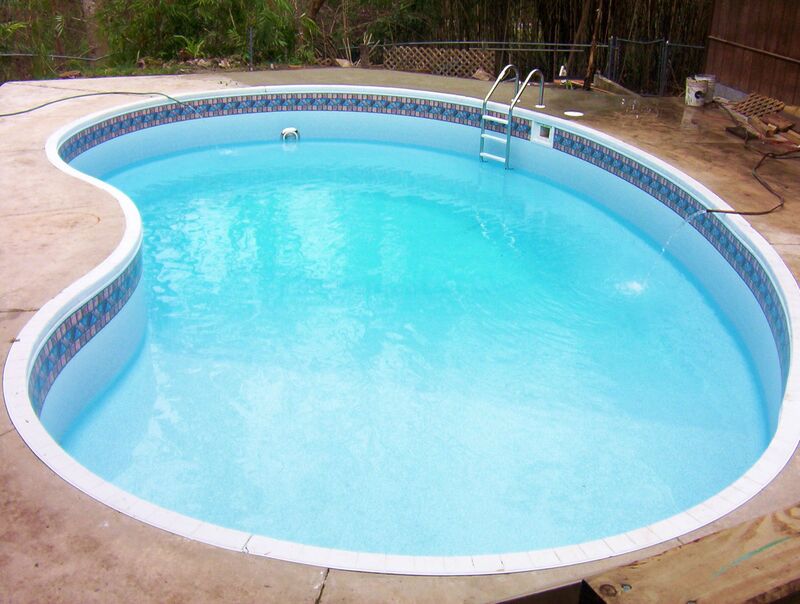 A Kidney Shaped Pool With Water After Cleaning